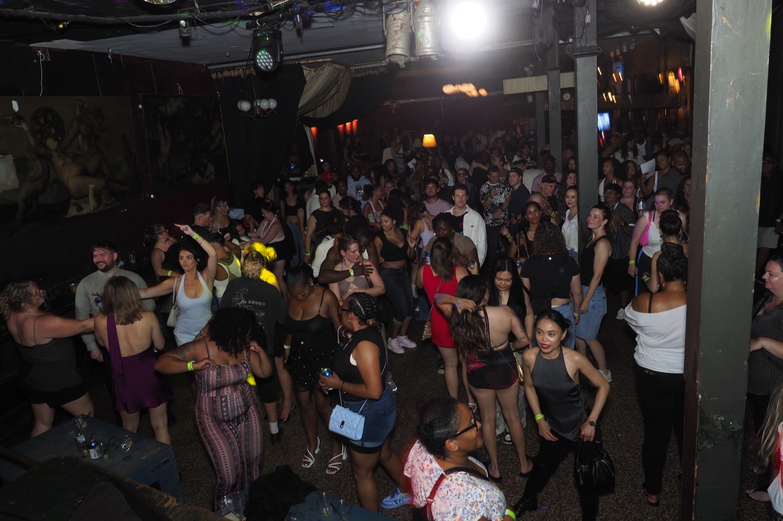 A packed dance floor full of people dancing